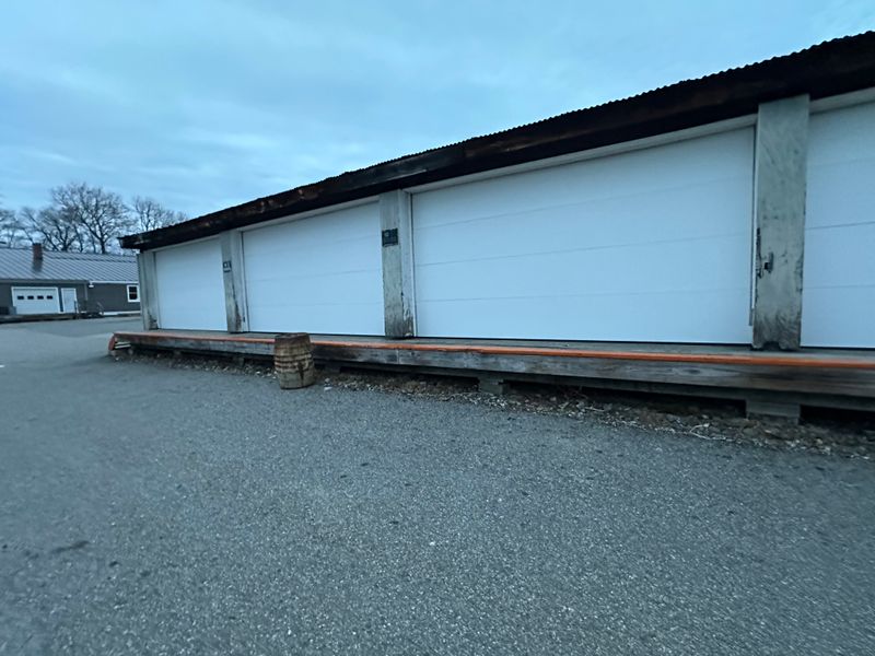 Close view of multi-bay commercial storage doors with raised loading dock