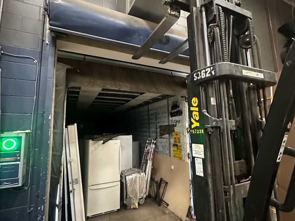 Raynor ControlHoist commercial opener being serviced on work van