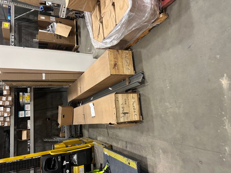 Garage door parts and materials on pallets in warehouse ready for installation
